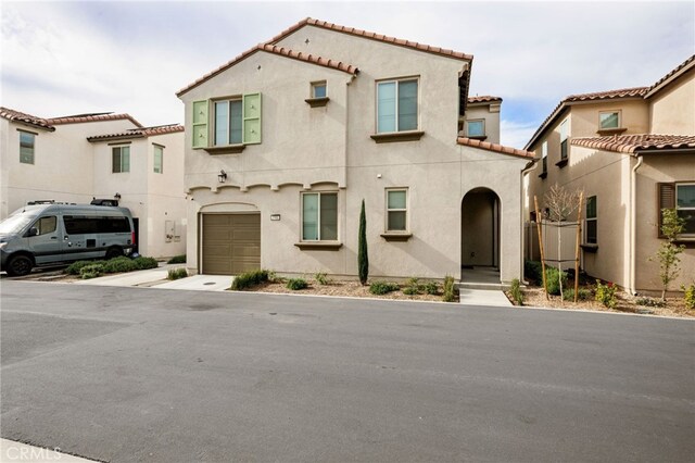 mediterranean / spanish house with a garage