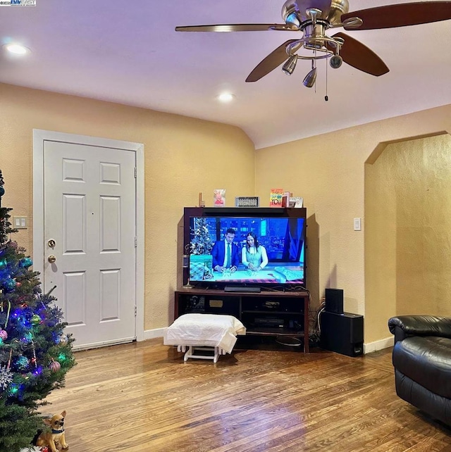 living room featuring wood-type flooring and ceiling fan