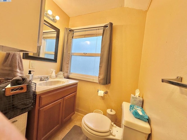 bathroom with tile patterned flooring, vanity, and toilet