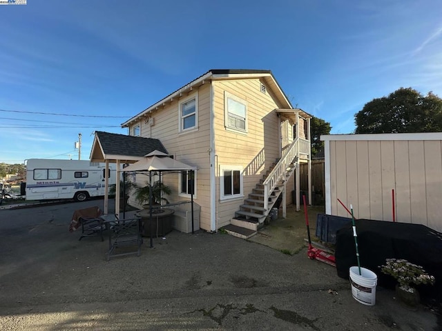 back of house with a gazebo