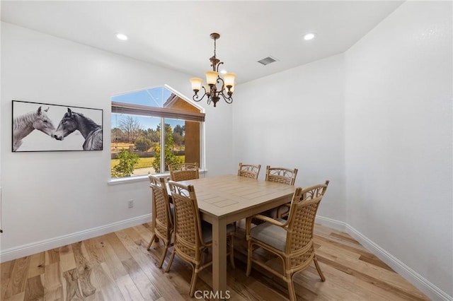 dining room featuring a chandelier and light hardwood / wood-style flooring