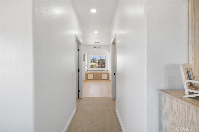 hallway with light colored carpet