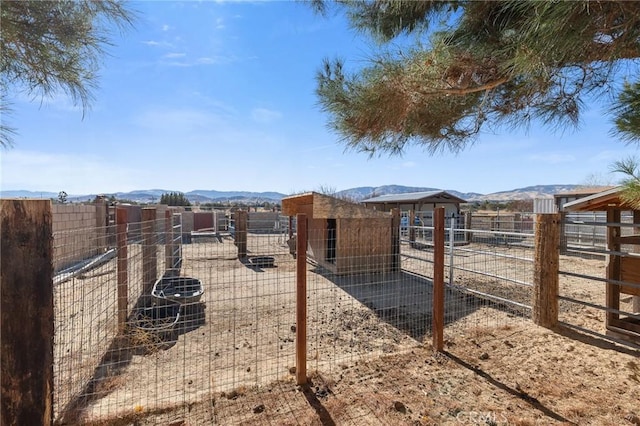 view of yard with a mountain view and an outbuilding