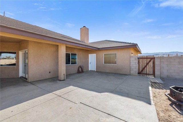 back of property with a patio