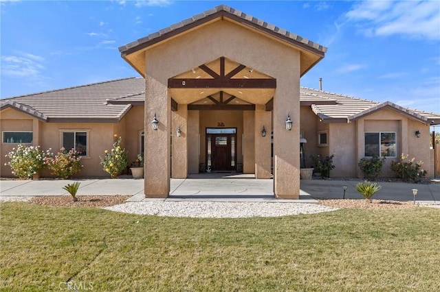 entrance to property with a lawn