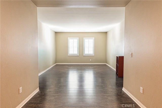 unfurnished room featuring dark wood-type flooring