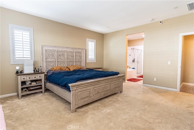 bedroom featuring light colored carpet and connected bathroom