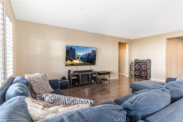 living room with dark wood-type flooring and a wealth of natural light