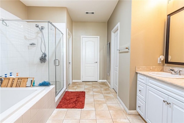 bathroom with tile patterned flooring, shower with separate bathtub, and vanity