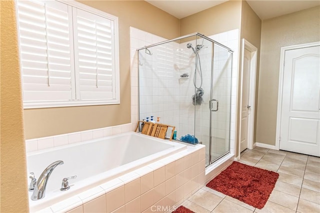 bathroom featuring tile patterned flooring and separate shower and tub