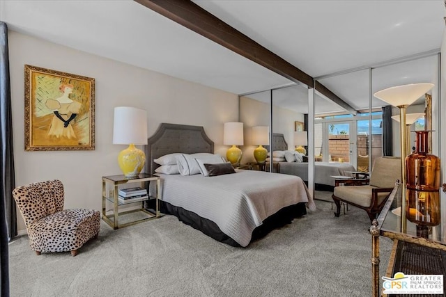 bedroom with carpet, a closet, and beamed ceiling