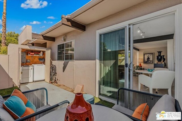 view of patio with separate washer and dryer