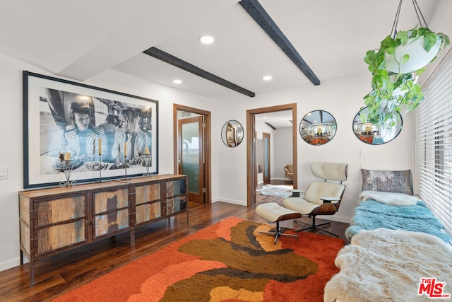 living room featuring dark hardwood / wood-style flooring and beam ceiling