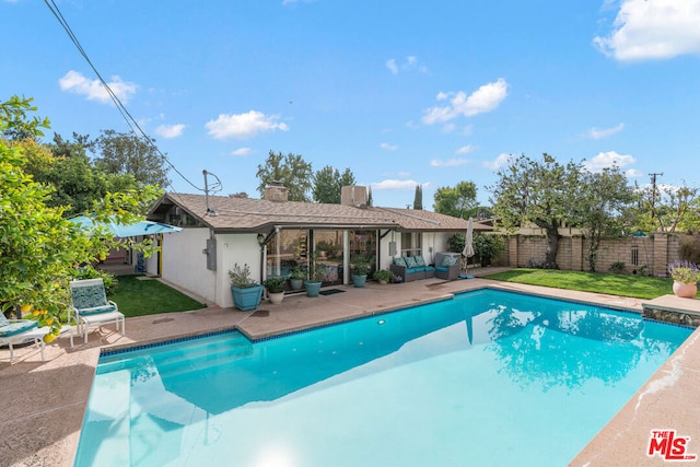 view of swimming pool featuring a yard and a patio