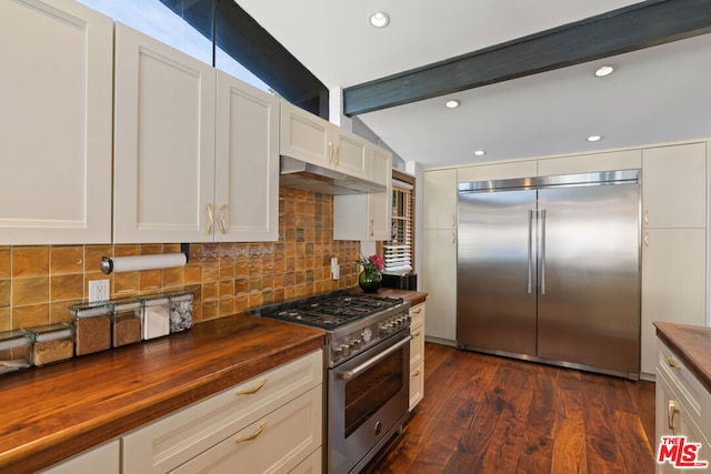 kitchen featuring dark wood-type flooring, high quality appliances, tasteful backsplash, butcher block countertops, and white cabinets