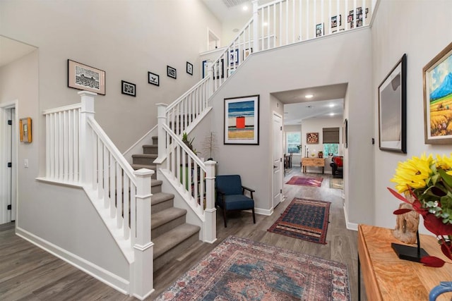 foyer with dark wood-type flooring and a high ceiling