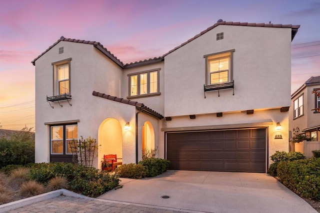 mediterranean / spanish-style house with a garage