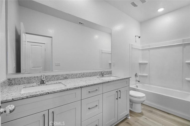 full bathroom with toilet, vanity, wood-type flooring, and bathing tub / shower combination