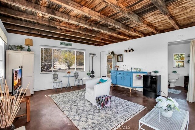 interior space with sink, wood ceiling, and beamed ceiling