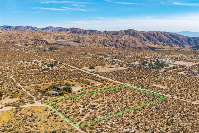 birds eye view of property with a mountain view