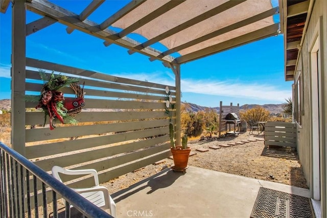 view of patio / terrace featuring a pergola and a mountain view