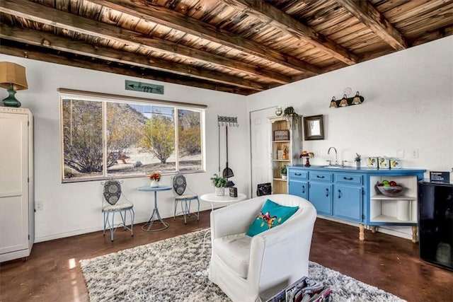 sitting room featuring wood ceiling, beam ceiling, and sink