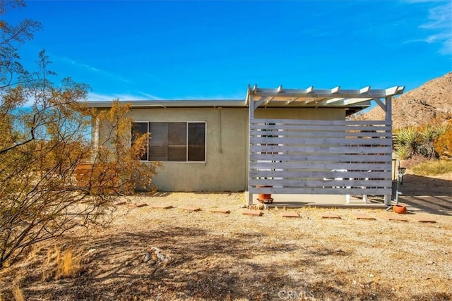 view of side of home featuring a pergola