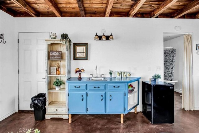 bar featuring wooden ceiling, sink, blue cabinetry, and beam ceiling