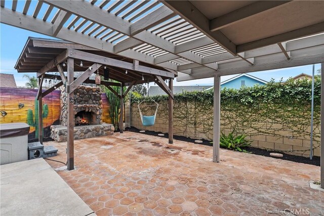 view of patio / terrace with an outdoor stone fireplace