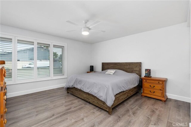 bedroom with ceiling fan and hardwood / wood-style flooring