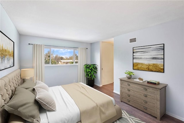 bedroom with dark hardwood / wood-style flooring