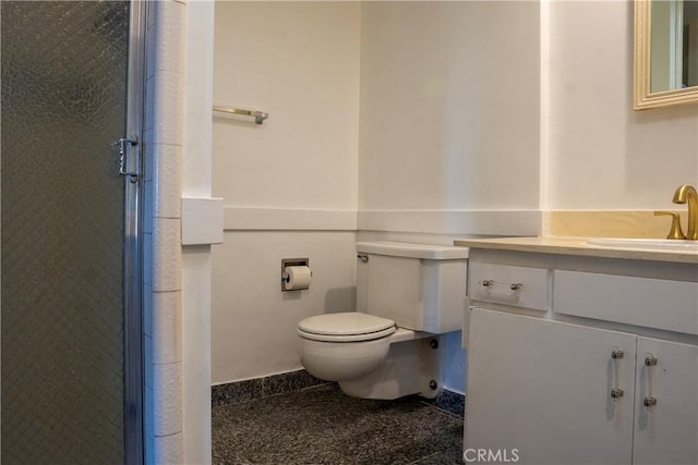 bathroom with an enclosed shower, vanity, and toilet