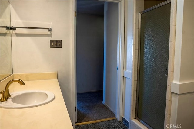 bathroom with a shower with door and vanity