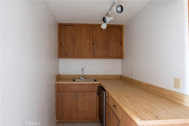 kitchen with light tile patterned flooring, track lighting, and sink