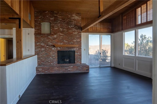 unfurnished living room with a healthy amount of sunlight, a fireplace, wood ceiling, and dark hardwood / wood-style flooring