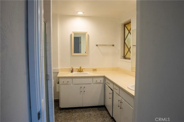 bathroom featuring an enclosed shower and vanity