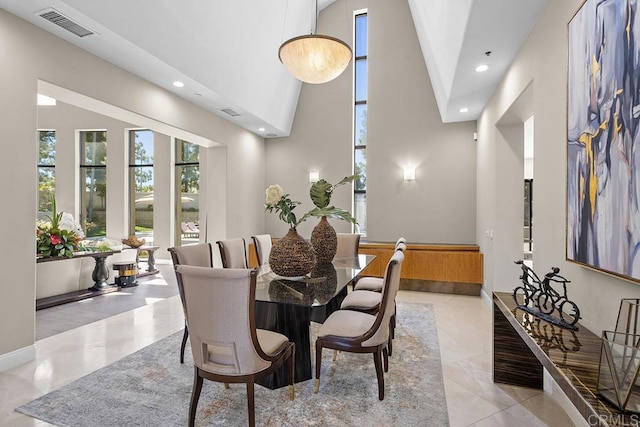 dining space with high vaulted ceiling