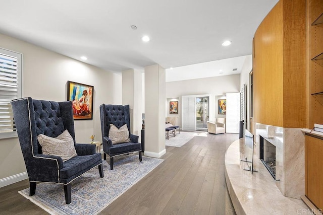 sitting room featuring wood-type flooring and a fireplace