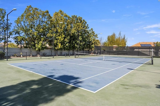 view of sport court with basketball hoop