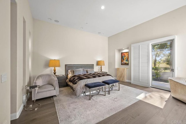 bedroom with hardwood / wood-style floors and access to outside