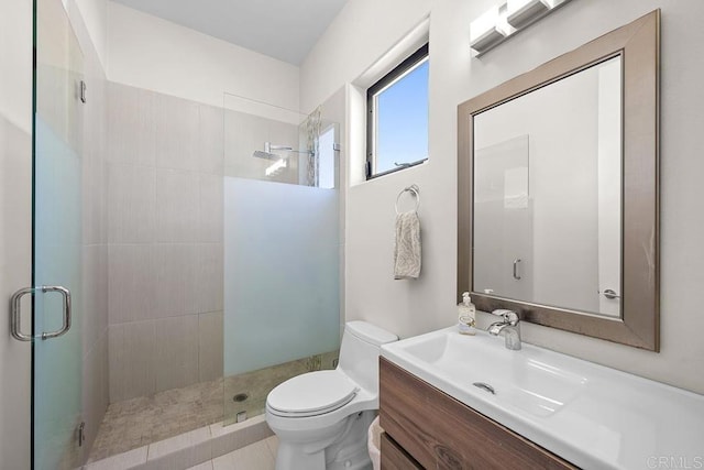 bathroom with toilet, vanity, and walk in shower