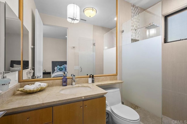 bathroom with toilet, vanity, and a shower