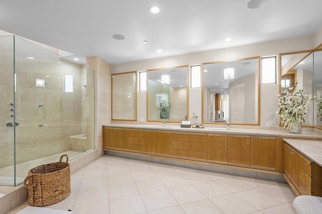 bathroom featuring walk in shower, vanity, and tile patterned floors