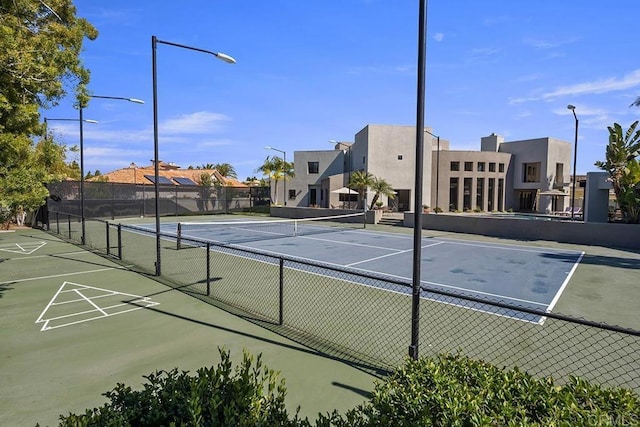 view of tennis court with fence