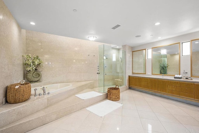 bathroom featuring double vanity, visible vents, a stall shower, a bath, and tile patterned flooring