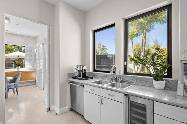 1107 Majestad Ln, Chula Vista, CA 91910 - bar featuring a sink, light tile patterned floors, wine cooler, baseboards, and dishwasher