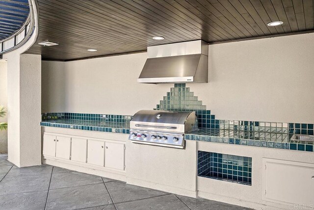 1107 Majestad Ln, Chula Vista, CA 91910 - exterior space with wall chimney exhaust hood, recessed lighting, white cabinets, and tile countertops