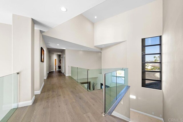 1107 Majestad Ln, Chula Vista, CA 91910 - hallway with wood finished floors, a high ceiling, recessed lighting, and baseboards