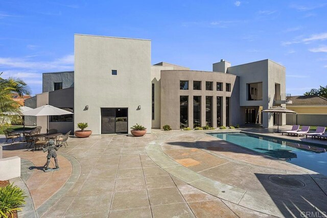 1107 Majestad Ln, Chula Vista, CA 91910 - rear view of property with an outdoor pool, stucco siding, and a patio area