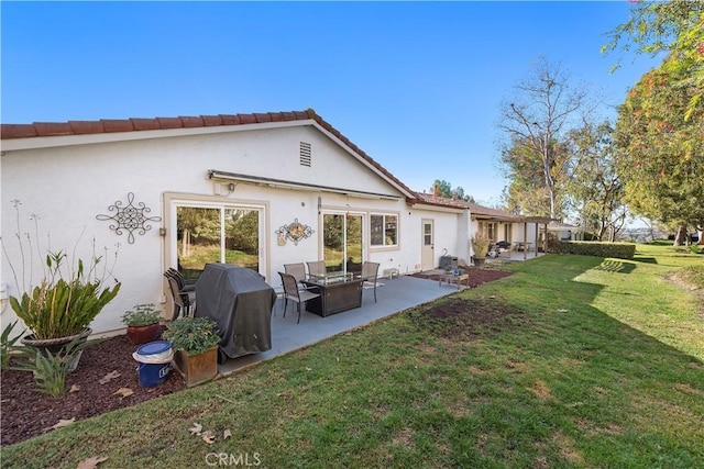 back of property featuring a yard and a patio